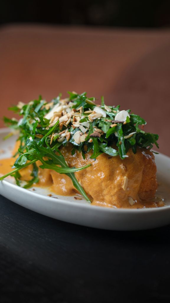 Запеченный батат с соусом том ям, рукколой и миндалем